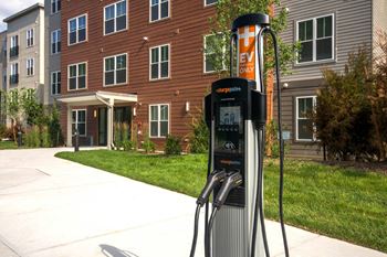 a gas pump in front of an apartment building